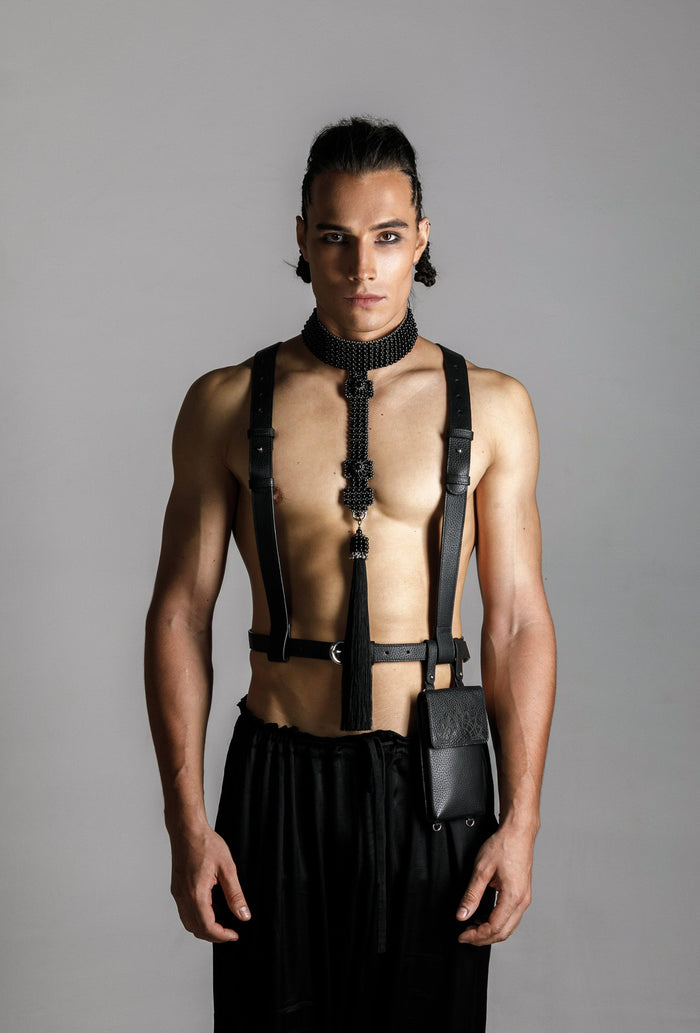 man wears elohim t-choker in jet black with leather harness and iphone bag black by object and dawn standing against grey background