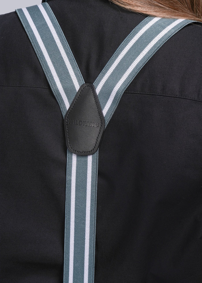 Close-up of suspenders on a model wearing black shirt