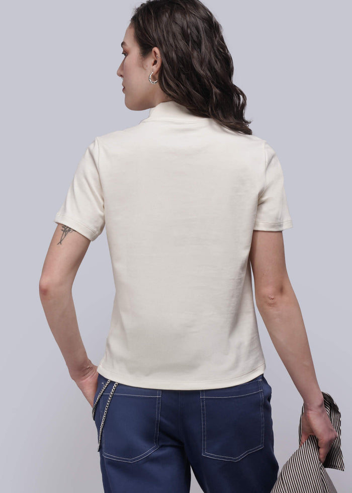 S=Back of person wearing a white shirt and blue jeans against a plain background