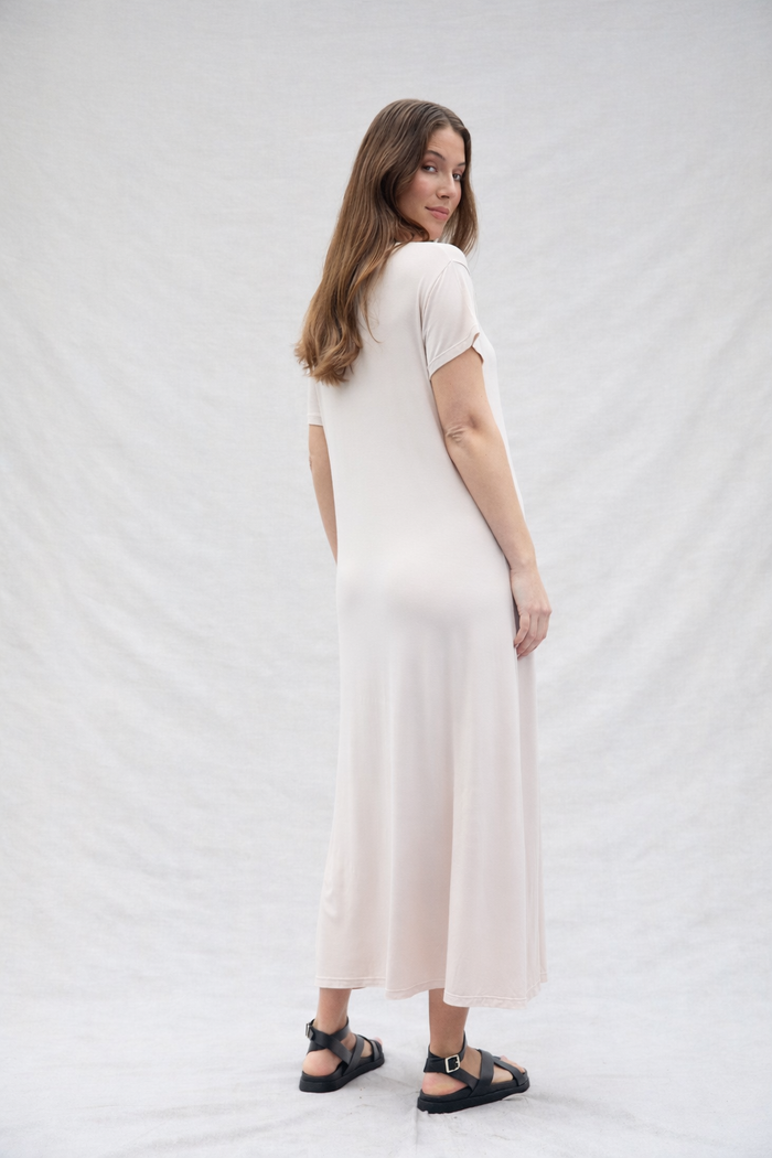 pregnant woman wearing bumpsuit weekend dress in cotton, oat color