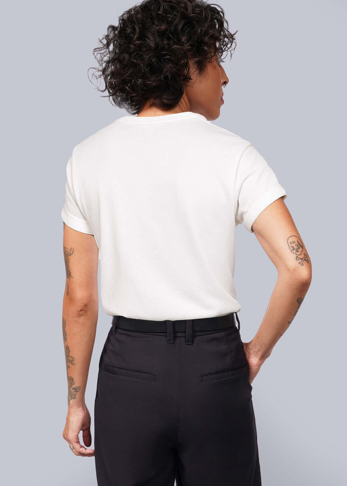 S=Person wearing a white t-shirt and black shorts against a plain background