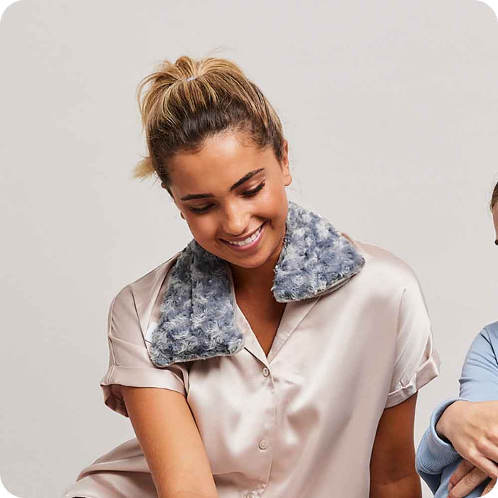 Woman smiling with Microwavable Curly Gray Warmies Neck Wrap