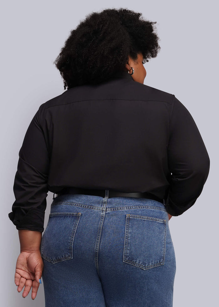 1X=A person shown from the back wearing a black long-sleeve button-up shirt and blue jeans against a light gray studio background.
