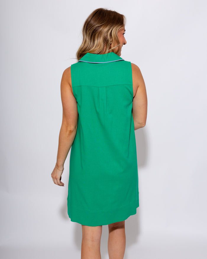 Green sleeveless mini dress with white contrast piping V-neck collar and front patch pockets, women's boutique dress at Gaudie & Co
