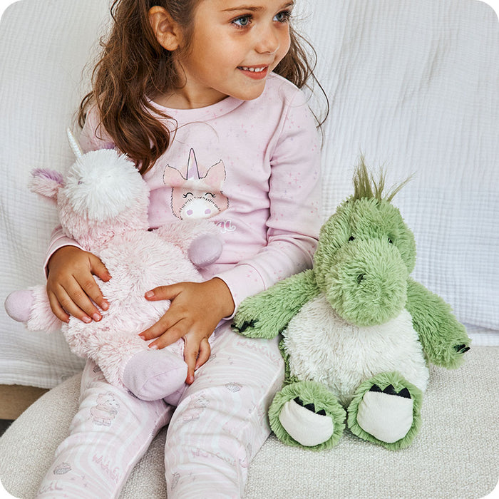 green dinosaur warmies stuffed animal on couch