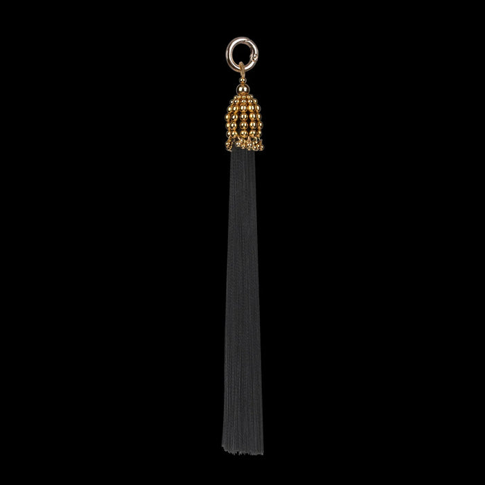 polyester beaded tassel by object and dawn in black background