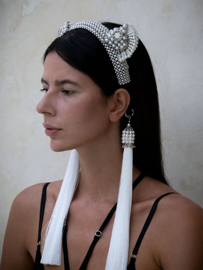 Woman in black outfit wears Jas Headband pearl with 11" tassels pearl by Object & Dawn in neutral backgorund