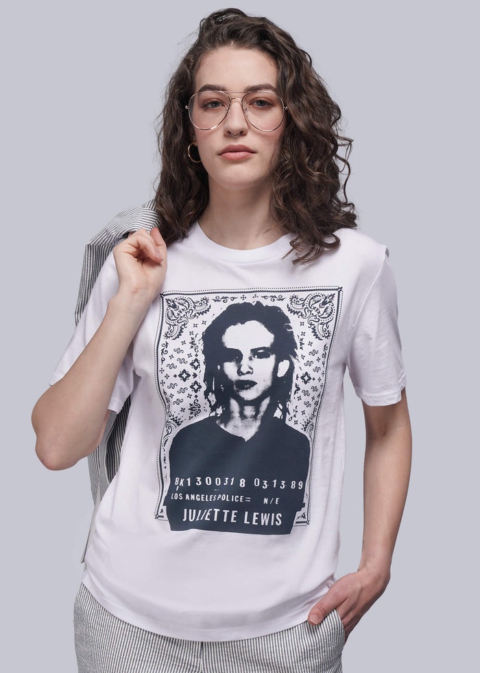 S=Person wearing a white t-shirt with a graphic design on a plain background