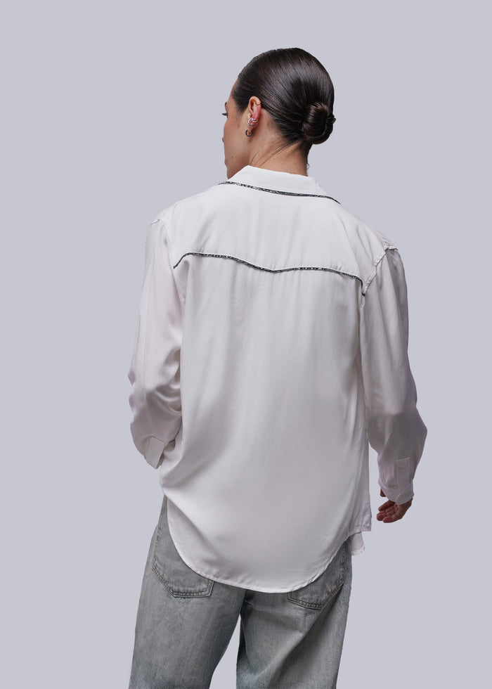 S=Back of person wearing a white shirt and pants on a plain background