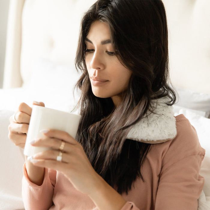 Woman wearing Soothing Warmies Neck Wrap in Marshmallow Brown