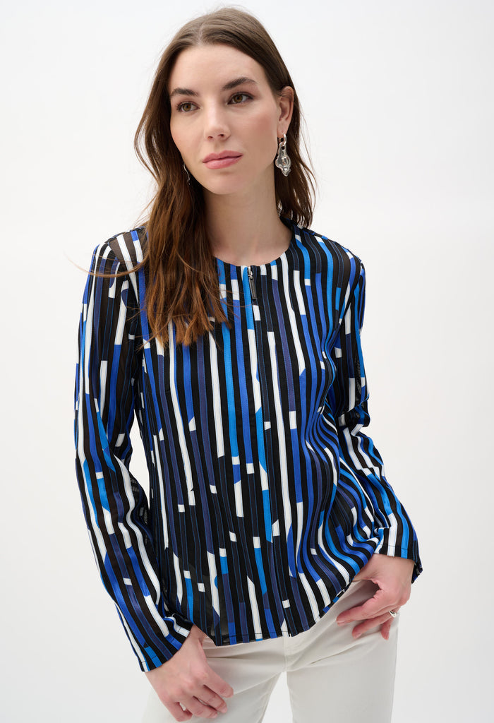 Woman wearing a blue and black patterned blouse on a white background