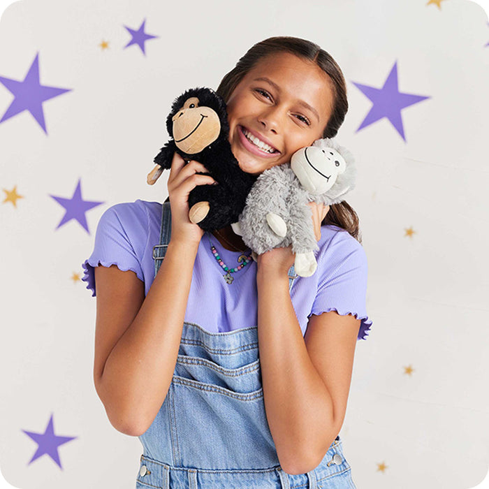 girl cuddling monkey hugs stuffed animals