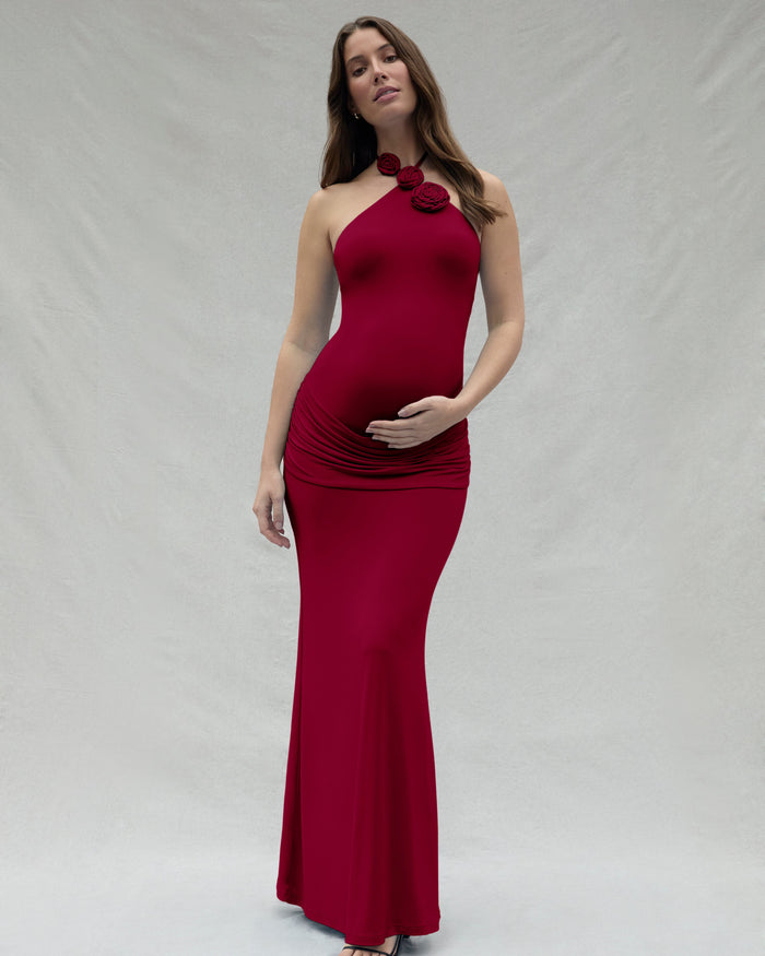 Woman wearing a burgundy dress with a floral detail on a white background
