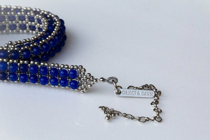 Handmade beaded blue crystals with polymer metal beads by object and dawn close up