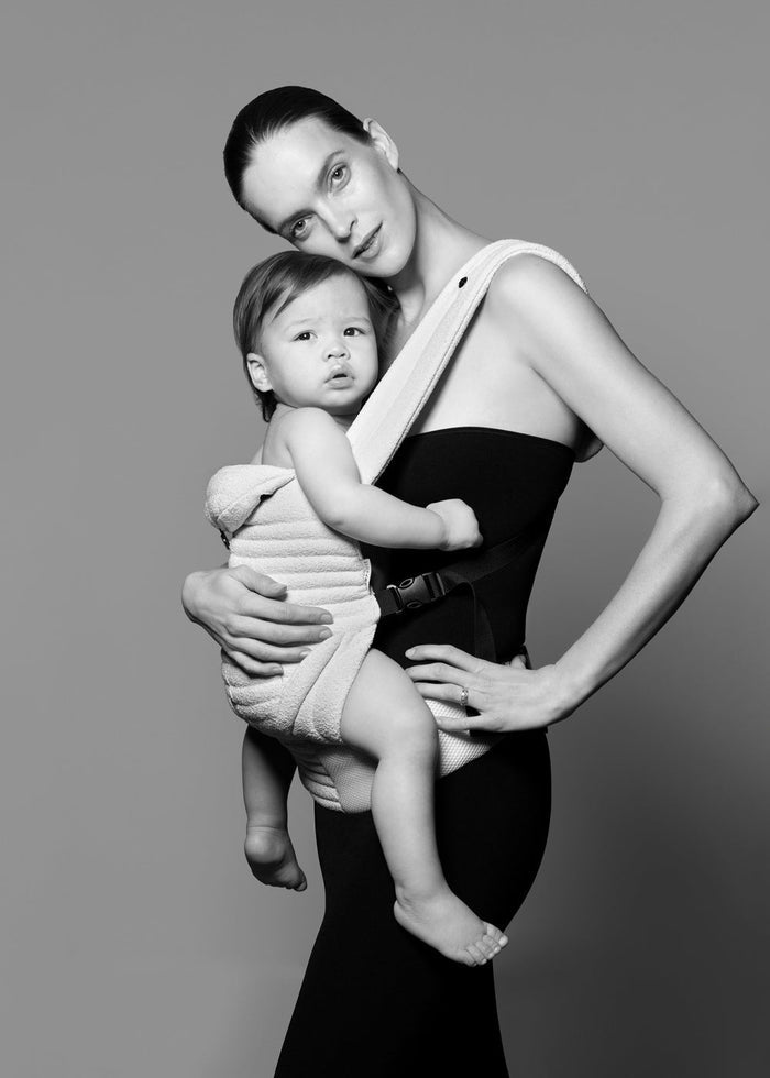 Model with a baby in the bumpsuit baby carrier shot in black and white