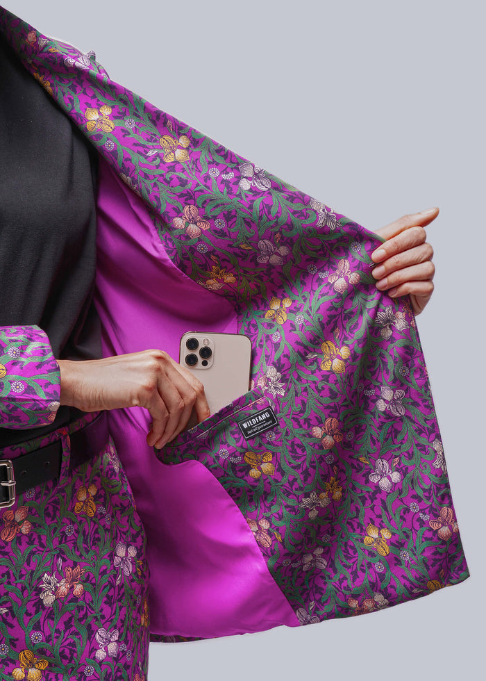 S=Person holding blazer open to show lining while placing phone inside interior pocket