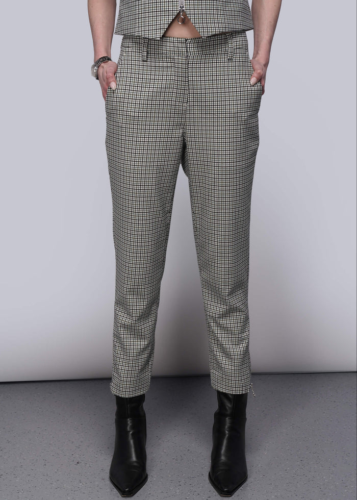 S=Person wearing plaid pants and black boots on a plain background