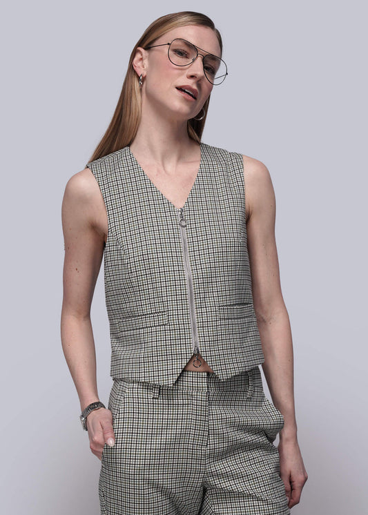 S=Person wearing a checkered vest and pants against a plain background