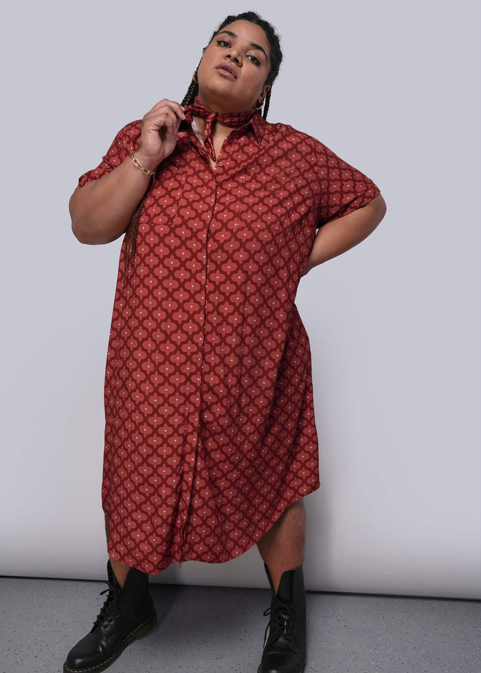 1X=Person wearing a red patterned dress against a white background