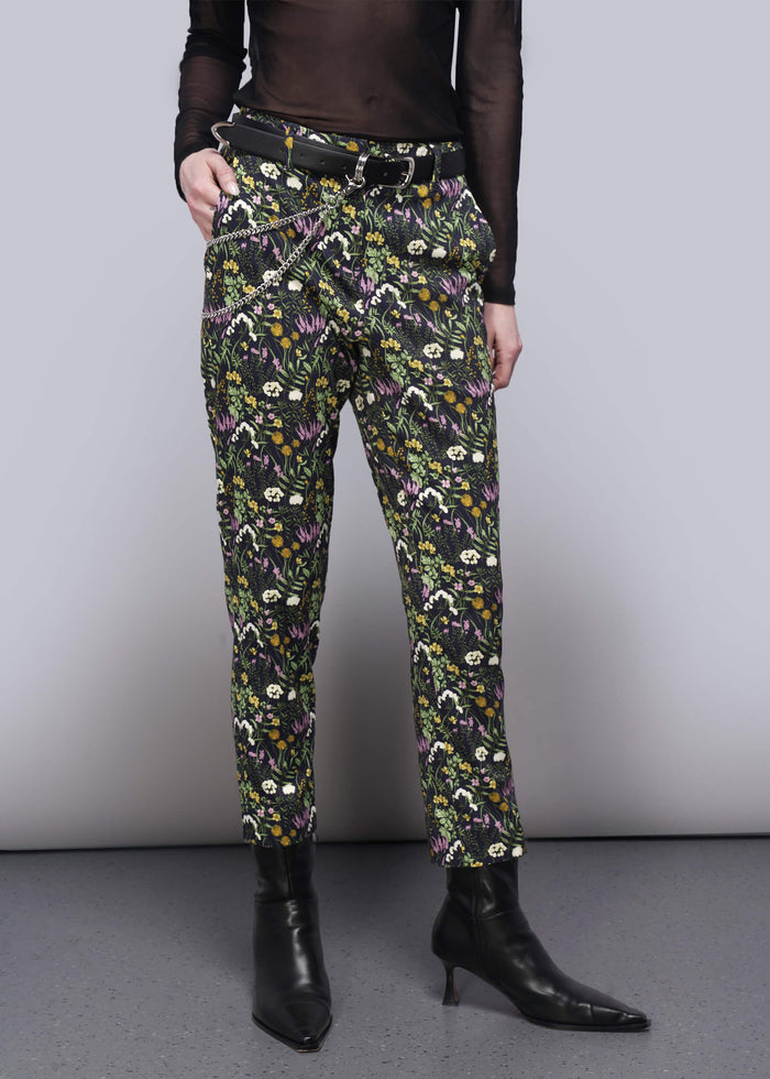 S=Floral patterned pants worn by a person on a plain background