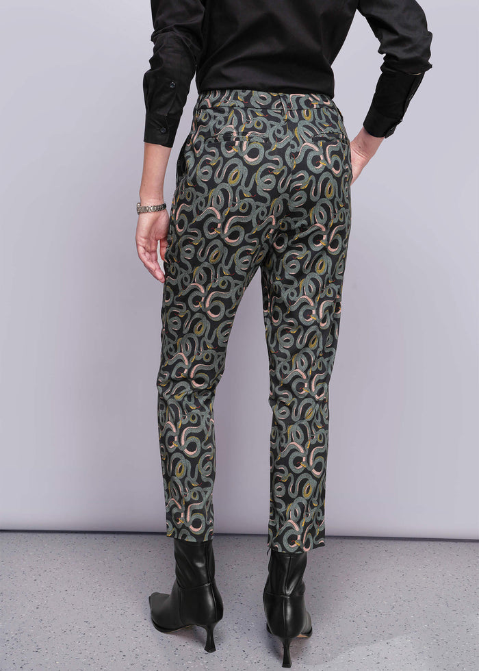 S=Person wearing patterned pants with a plain background