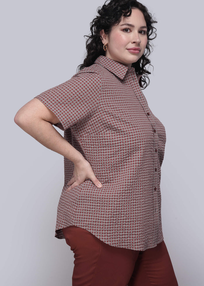 1X=Person wearing a red checkered shirt and red pants against a white background