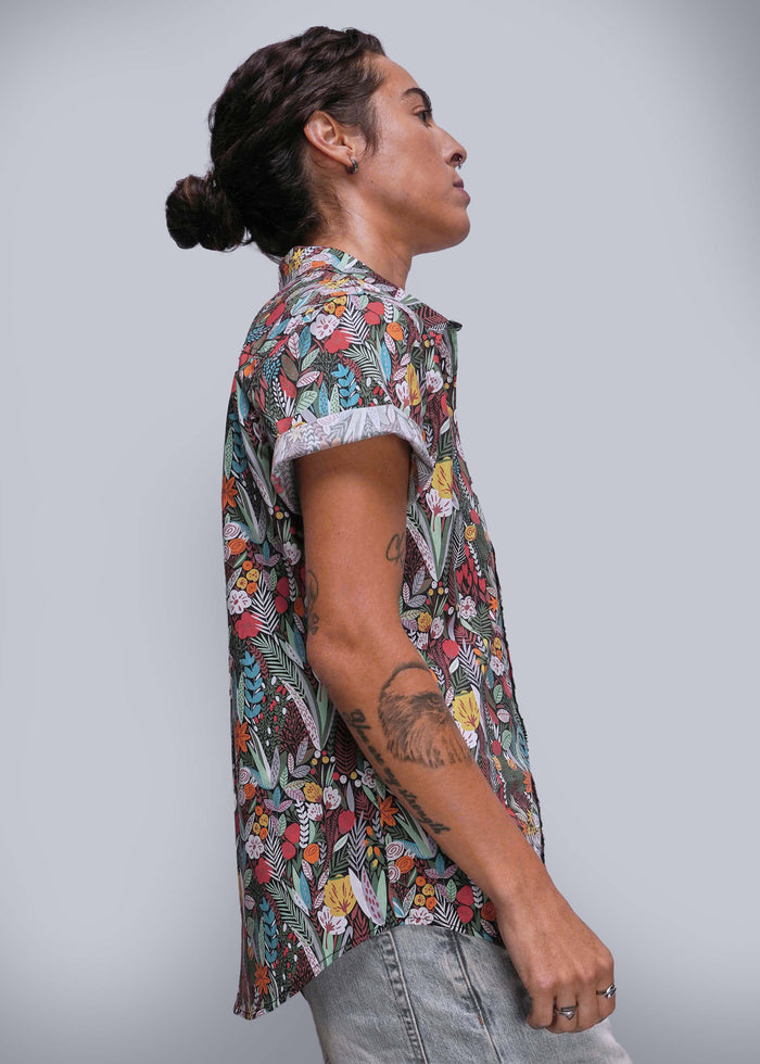 S=Person wearing a colorful floral shirt against a plain background