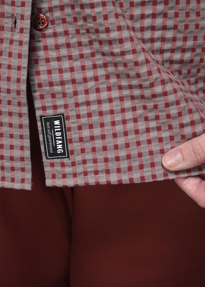 1X=Close up of red checkered shirt with a visible brand label