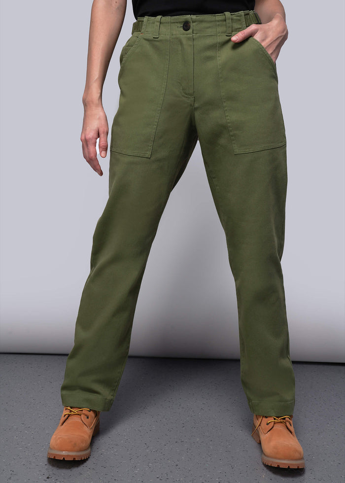 S=Person wearing green pants and brown boots on a gray background