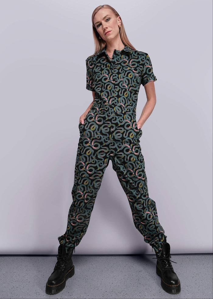 S=Person wearing a patterned jumpsuit on a plain background