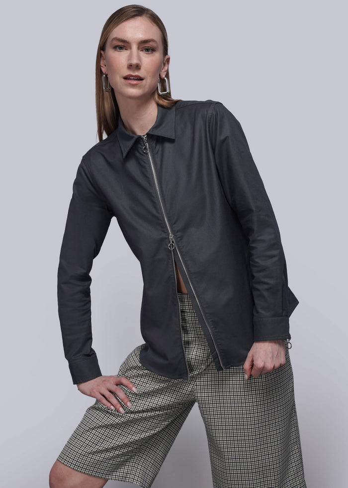 S=Person wearing a black zip up shirt, checkered shorts, and black boots on a plain background