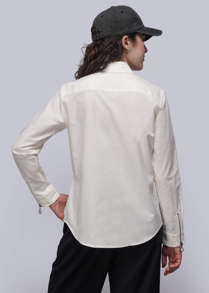 S=Back of person wearing a white shirt and black pants with a plain background