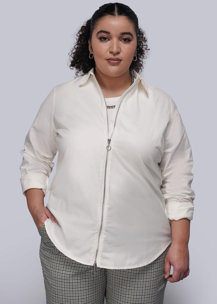 1X=Person wearing a white shirt with zipper and plaid pants on a plain background