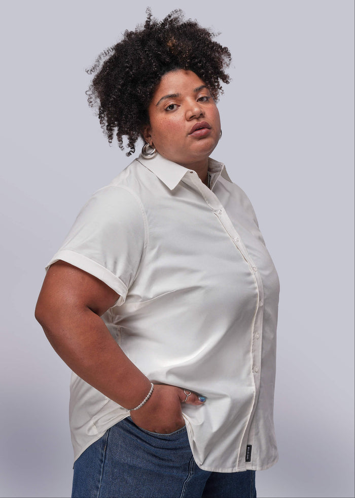 1X=Person wearing a white shirt and blue jeans against a plain background