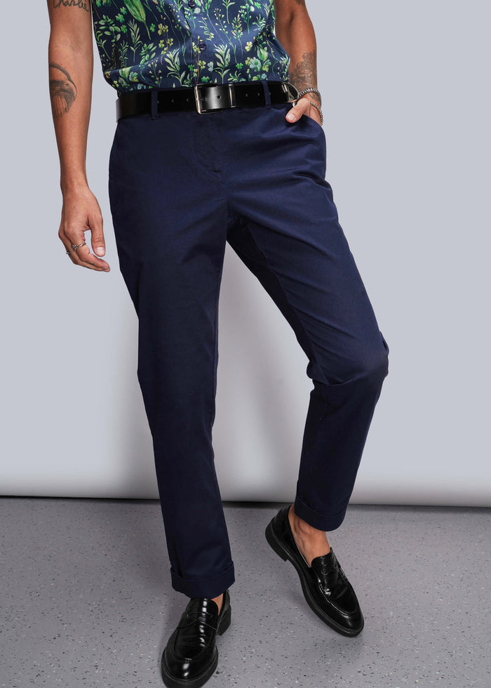 S=Person wearing navy pants and black shoes on a plain background