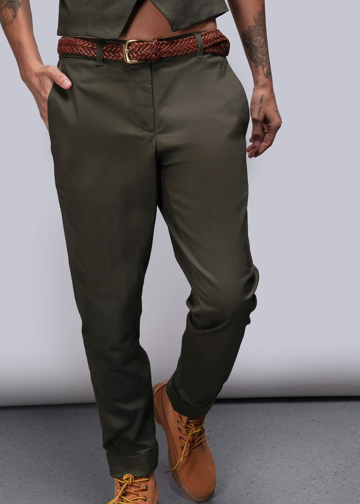 S=Person wearing olive green pants with a brown belt and shoes on a plain background