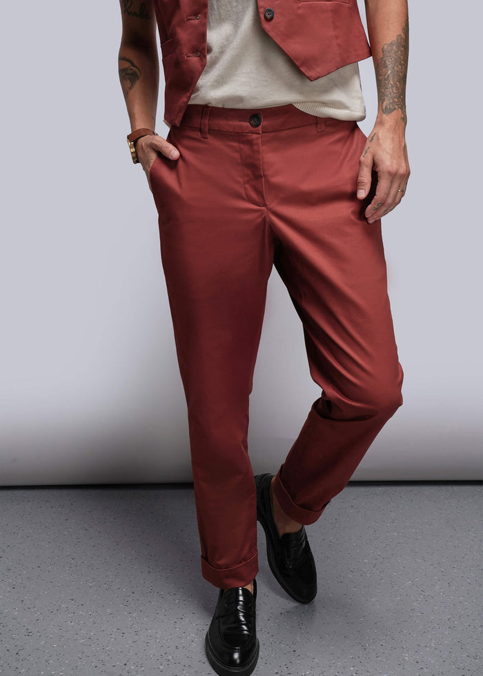 S=Person wearing cinnamon colored pants and a cinnamon vest against a plain background
