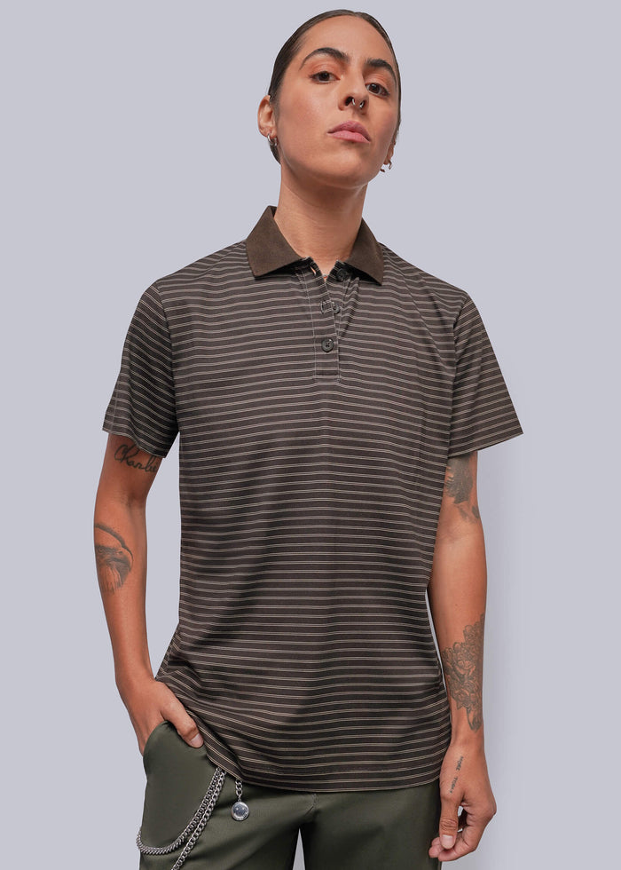 S=A model wearing a dark brown and black horizontally striped short-sleeve polo shirt with a solid dark brown collar, paired with olive green pants, against a solid gray background.