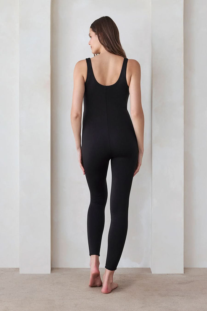 Back view of a woman wearing the Bumpsuit Maternity Lucy Sleeveless Scoop Neck Jumpsuit in Black