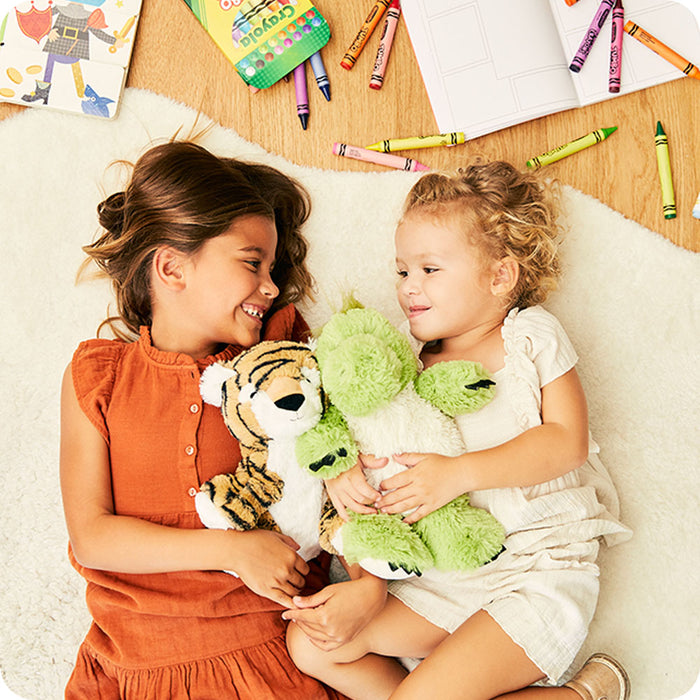 kids playing with tiger stuffed animal and dinosaur stuffed animal warmies