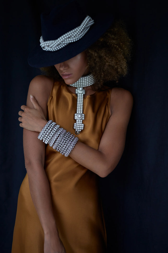 Beaded modular hat accessory from polymer metal beads and syntethis japananese pearl by object and dawn on neutral background